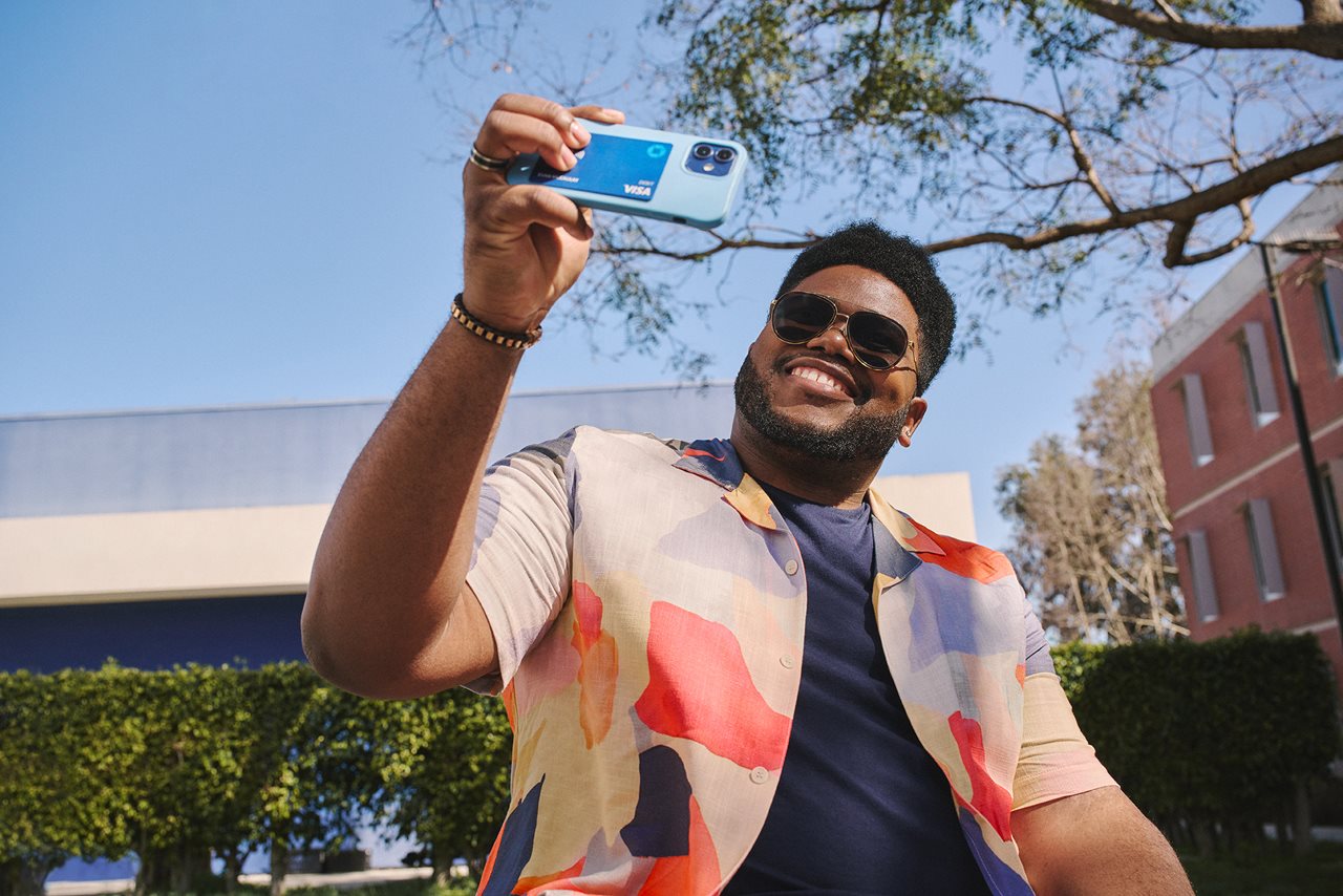 Young man taking a selfie on campus.