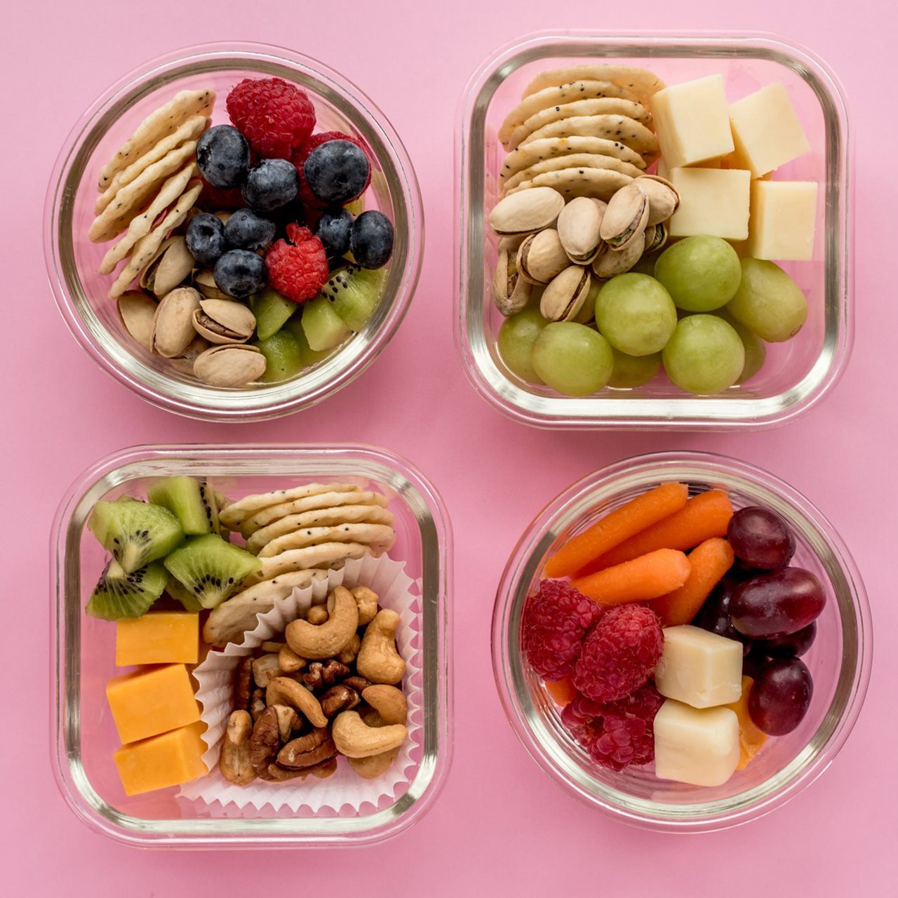 small containers with nuts, berries, crackers and cheese.