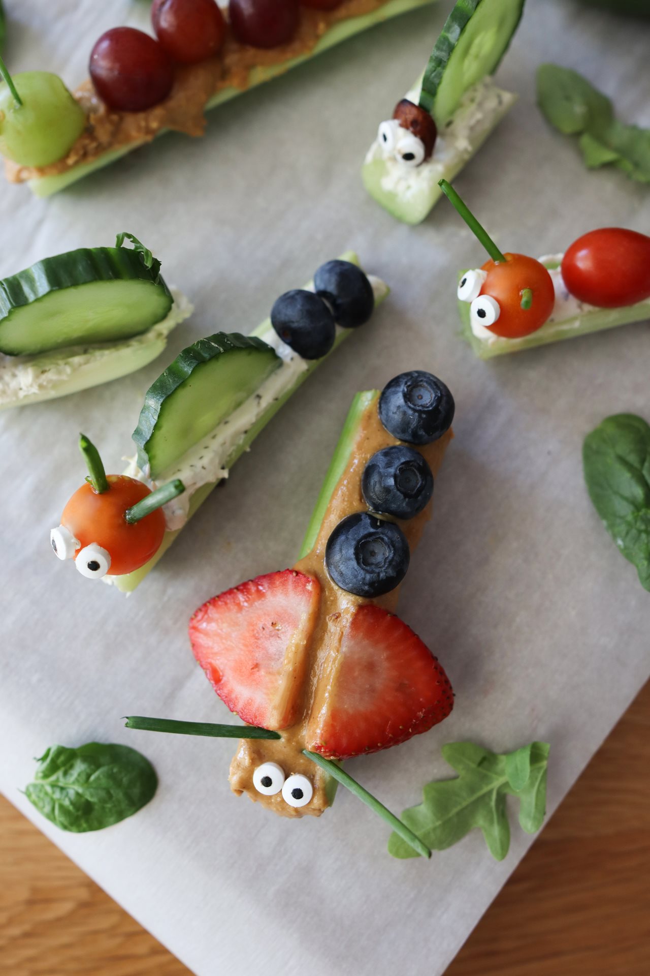 Celery stick, peanut butter, black olives and strawberries combine to make adorable animal critters.