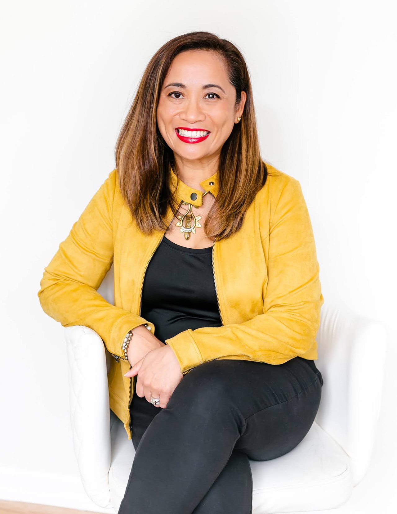 Tif Marcello smiling against a white backdrop