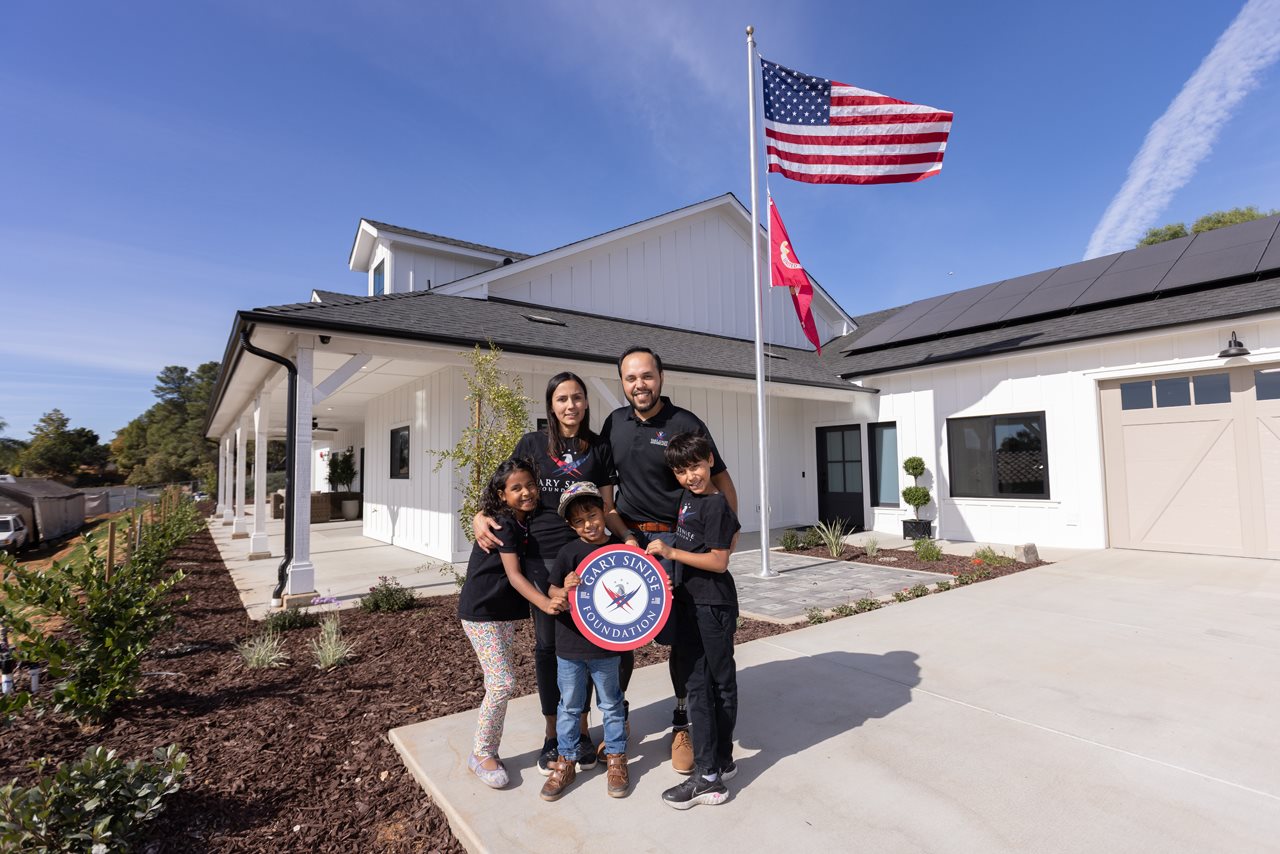 Jose Armenta and his family in front of their house.