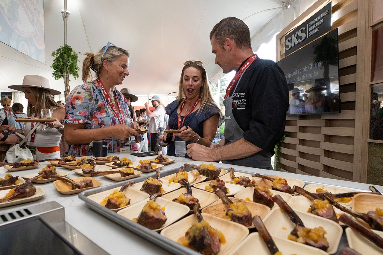 People sampling a lamb recipe at the food and wine classic in Apsen