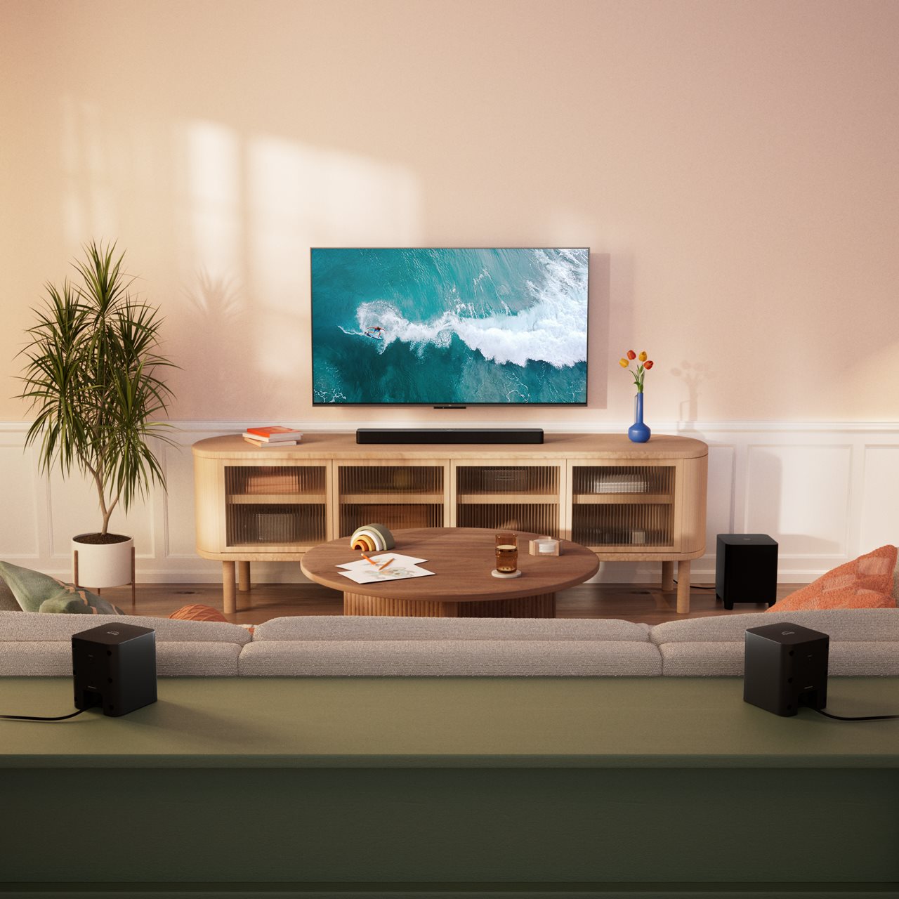 large screen tv and sound bar plus speakers over a cabinet