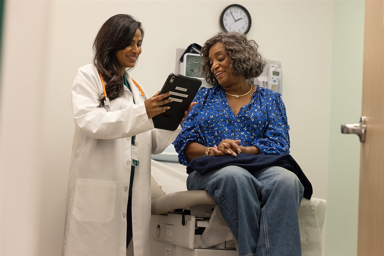 Senior talking with a doctor in her office aout a dienosis.