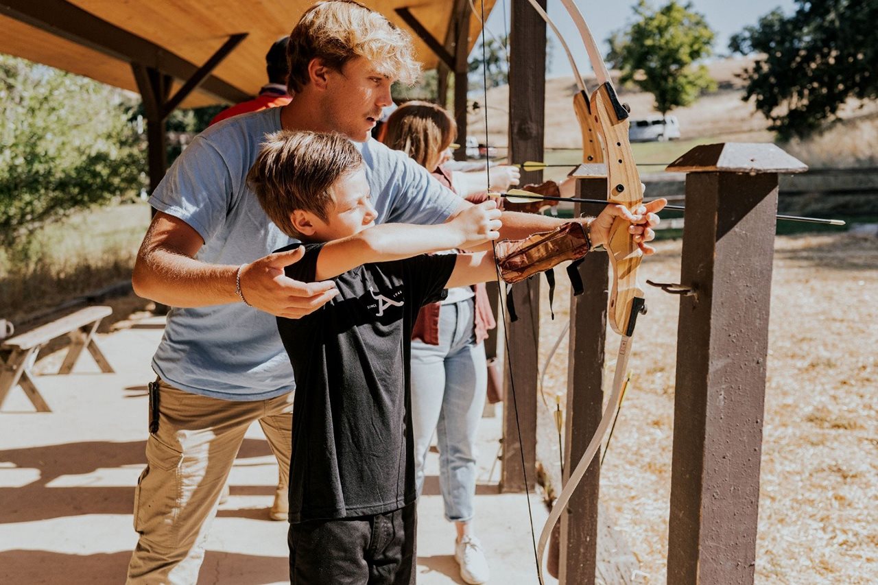 Young man learning archery at the Alisal Ranch.