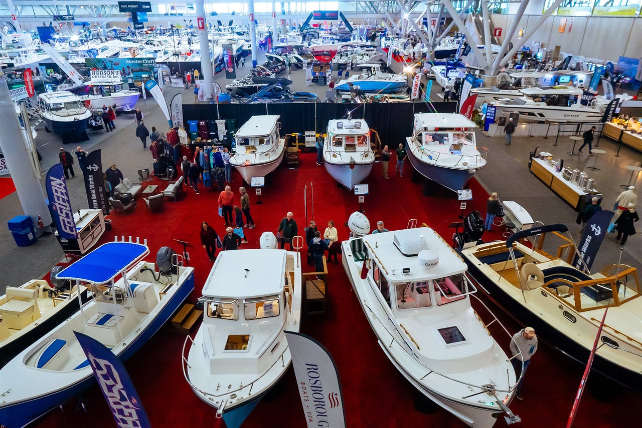 Boaters dreaming of a Summer on the water while comparing boats on the show floor at the National Marine Manufacturers Association Boat Show.