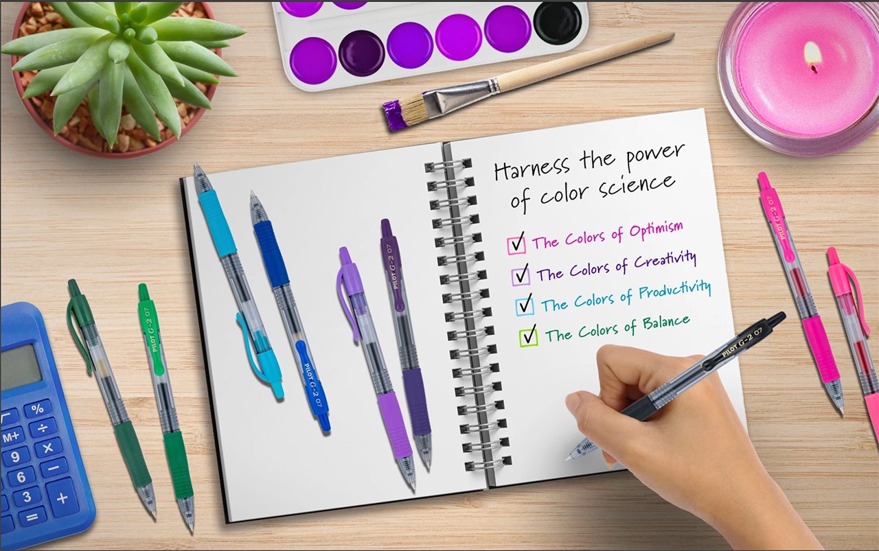 Illusration of a person using a Point Boost Pilot Pen to write a notebook while sitting at a desk with colorful paints and candle.
