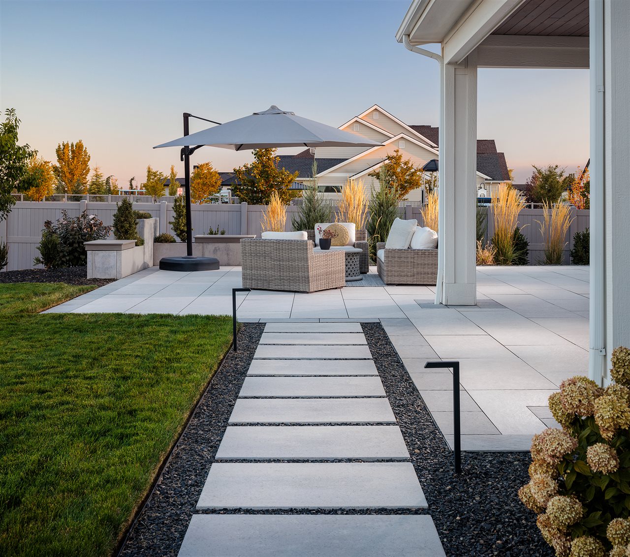 Belgard dimension slab pathway leading to an firepit and outdoor living area with comfortable furniture.