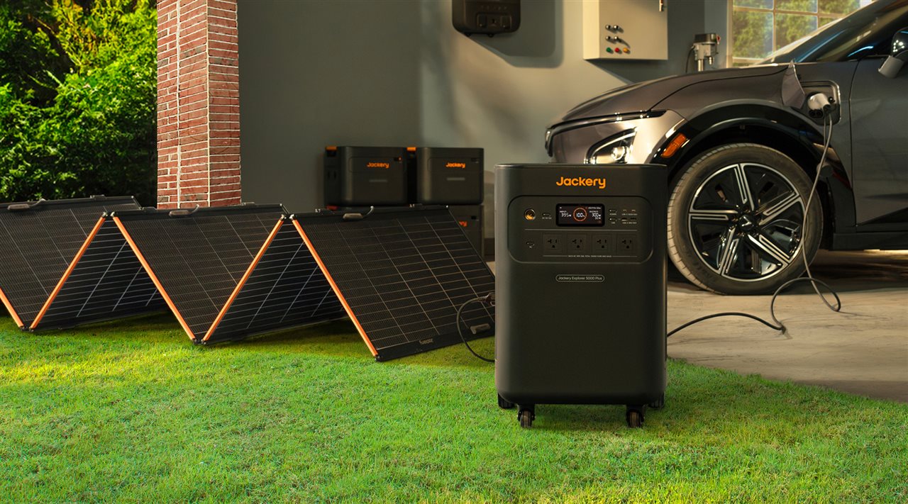 Car in the garage charging up for the next road trip using Jackery solar powered generator.