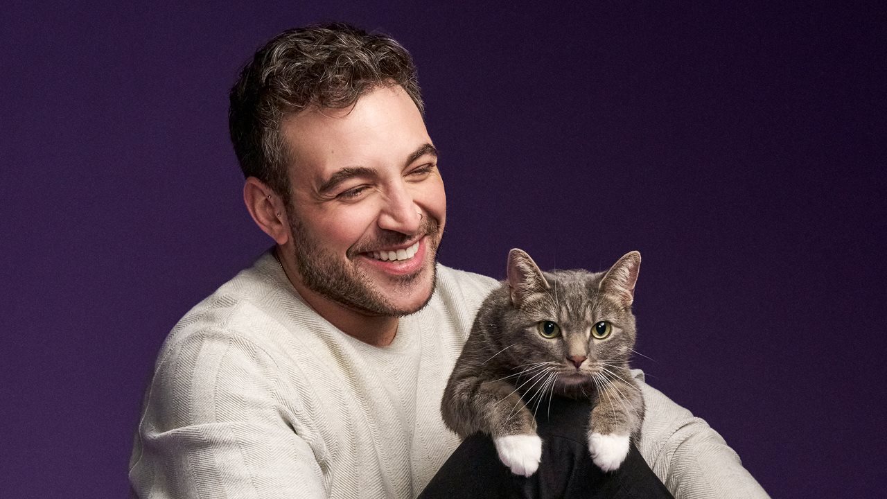 Cat dad with cat on his lap.
