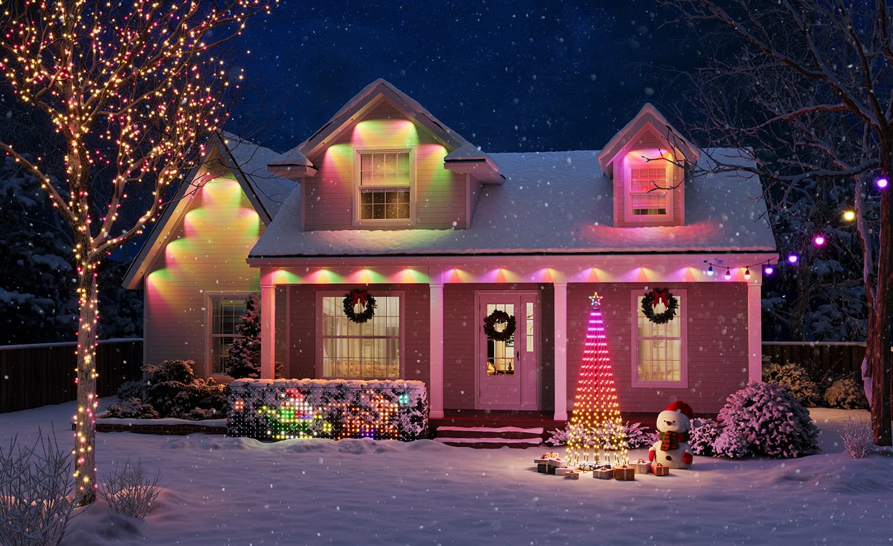 LED lights decorate a house, trees, shrubs and Christmas tree.